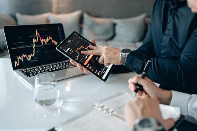 Two people analyzing financial charts